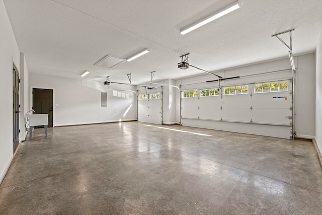 garage featuring electric panel and a garage door opener