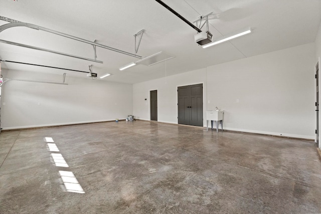 garage with a garage door opener and sink