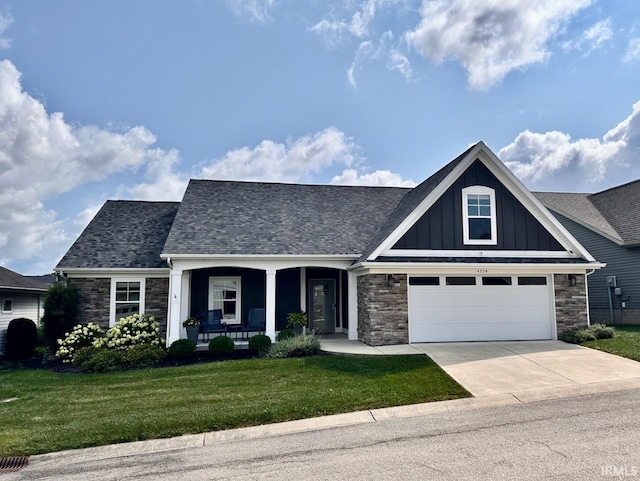 craftsman inspired home with covered porch, concrete driveway, stone siding, a front lawn, and board and batten siding