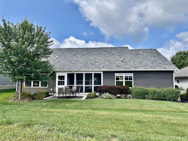 rear view of house with a patio and a yard