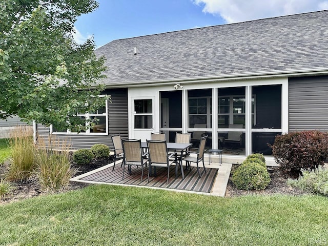 back of property with a lawn and a patio area