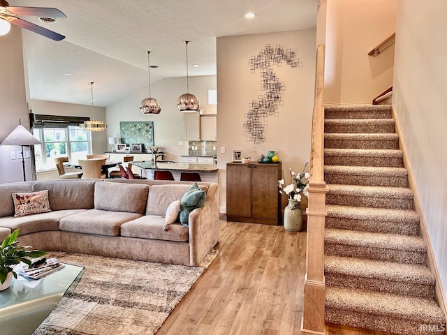 living room featuring ceiling fan, high vaulted ceiling, and light hardwood / wood-style floors