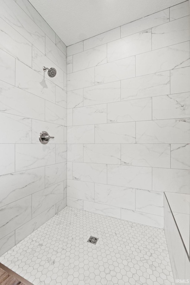 full bath featuring tiled shower