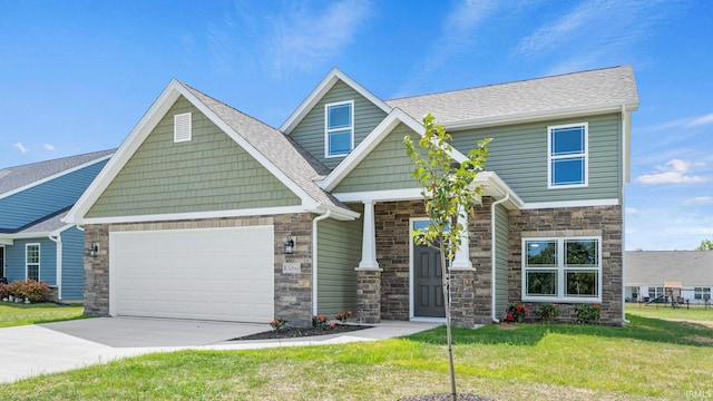 craftsman house featuring a garage and a front yard