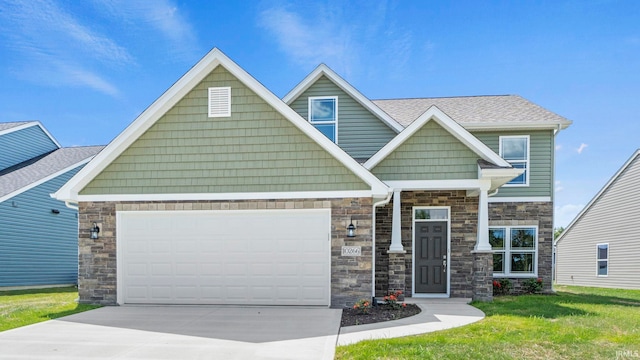 craftsman-style house featuring a front lawn and a garage