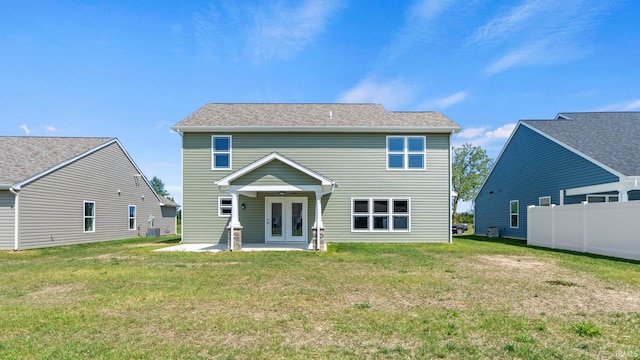 rear view of house with a yard, a patio, and french doors