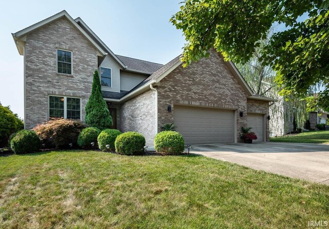 view of front of property featuring a garage and a front lawn