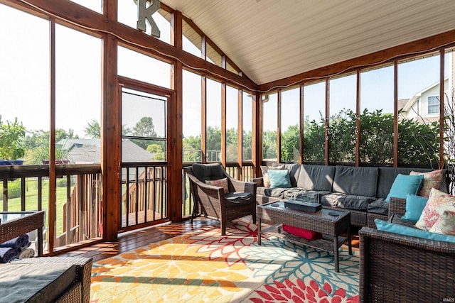 sunroom with vaulted ceiling and a healthy amount of sunlight