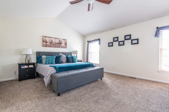 carpeted bedroom with ceiling fan and vaulted ceiling