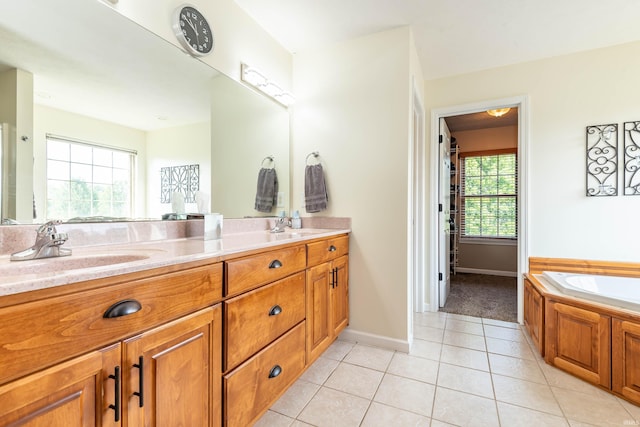 bathroom with vanity, a bath, and tile patterned floors