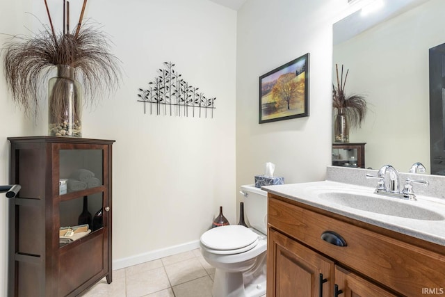 bathroom with tile patterned flooring, vanity, and toilet