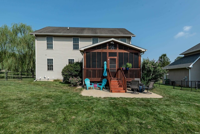 rear view of house featuring a patio area, a sunroom, and a lawn