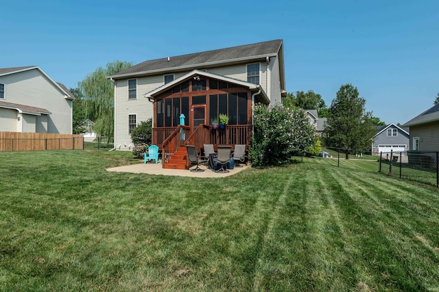 back of property featuring a sunroom, a lawn, and a patio area