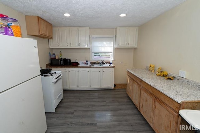 kitchen featuring sink, a textured ceiling, white appliances, and dark hardwood / wood-style flooring