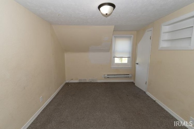 additional living space featuring a textured ceiling, carpet, and a baseboard radiator