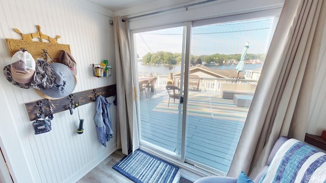 doorway featuring a water view and wood finished floors