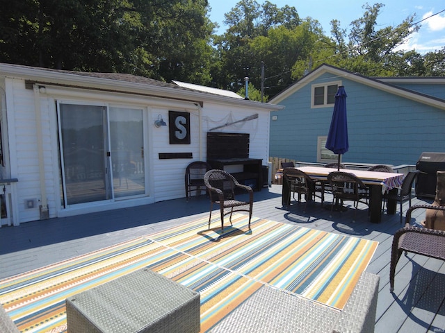 deck featuring outdoor dining area