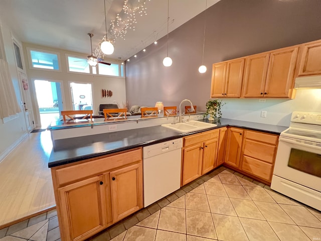 235 N Main St, Kokomo, IN 46901 - kitchen with white appliances, a sink, a ceiling fan, a peninsula, and dark countertops