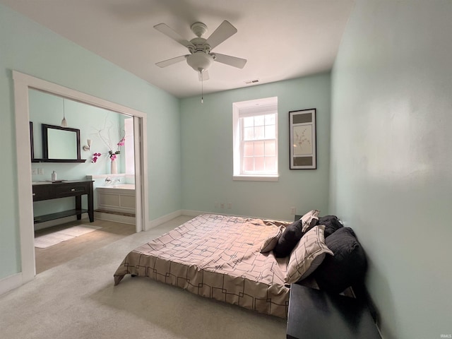 235 N Main St, Kokomo, IN 46901 - bedroom with carpet floors, baseboards, a ceiling fan, and ensuite bathroom