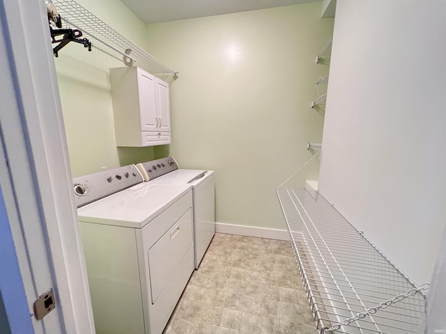 235 N Main St, Kokomo, IN 46901 - laundry area featuring washing machine and clothes dryer, cabinet space, and baseboards