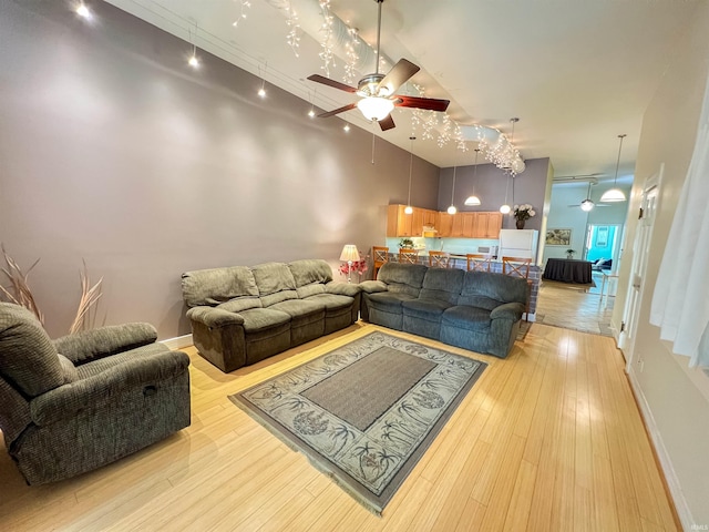 235 N Main St, Kokomo, IN 46901 - living area with ceiling fan, light wood finished floors, a towering ceiling, and baseboards