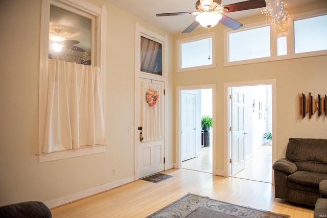 235 N Main St, Kokomo, IN 46901 - entryway with wood finished floors, a ceiling fan, a high ceiling, and baseboards
