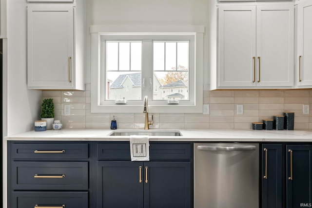 kitchen with white cabinetry, sink, and stainless steel dishwasher