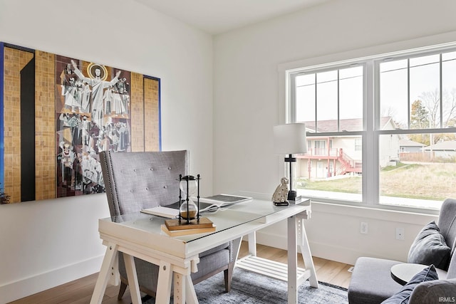 home office with plenty of natural light and wood-type flooring