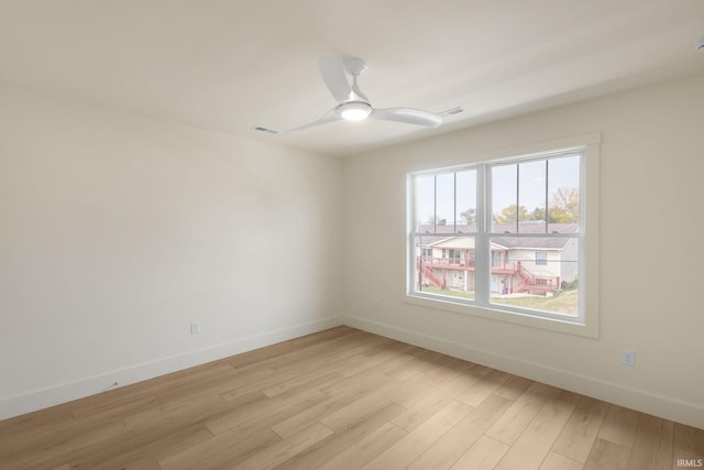 spare room featuring ceiling fan and light hardwood / wood-style flooring