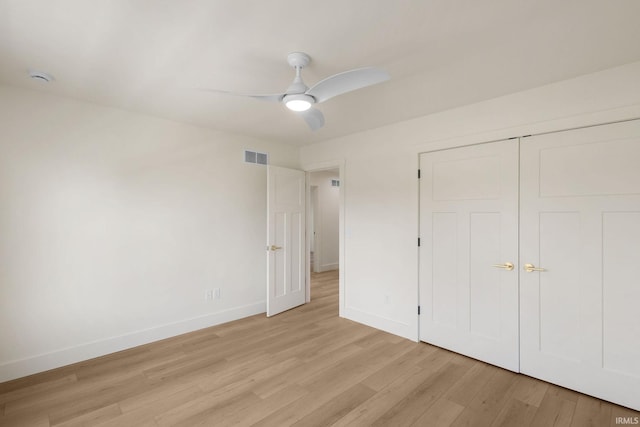 unfurnished bedroom with ceiling fan, a closet, and light hardwood / wood-style flooring