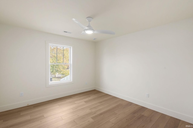 empty room with ceiling fan and light wood-type flooring