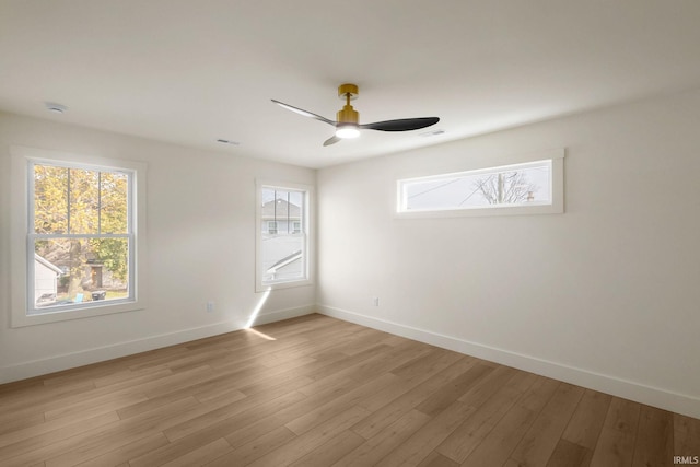 unfurnished room featuring ceiling fan, light hardwood / wood-style floors, and a healthy amount of sunlight