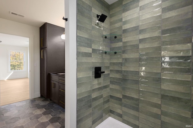 bathroom featuring vanity and a tile shower