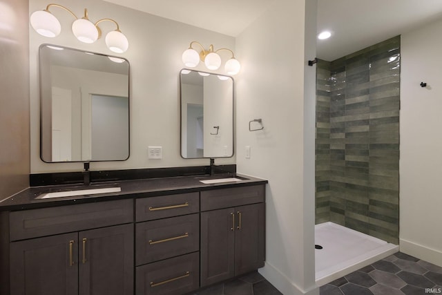 bathroom with vanity, tile patterned flooring, and tiled shower