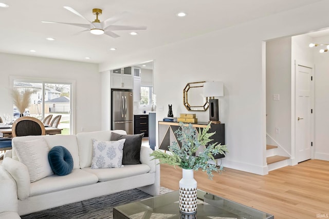 living room featuring hardwood / wood-style floors and ceiling fan