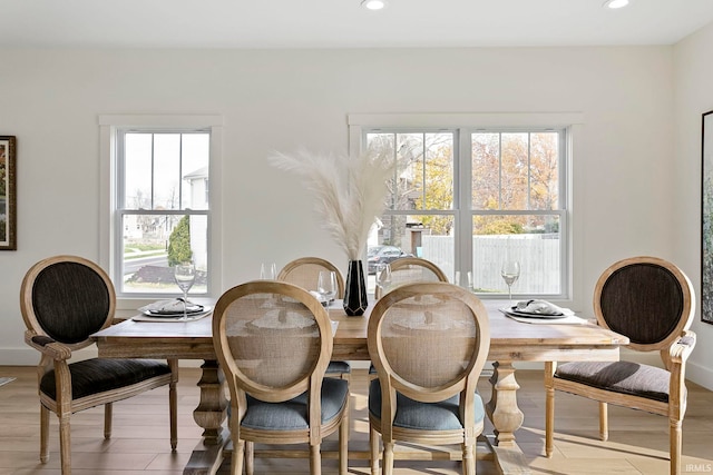 dining space with light hardwood / wood-style floors