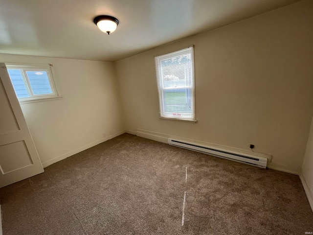 carpeted spare room featuring a baseboard radiator