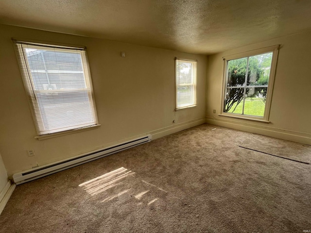 spare room with a textured ceiling, light carpet, and a baseboard radiator