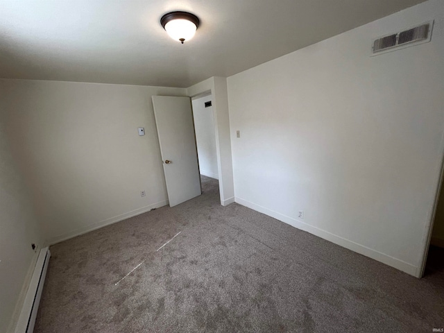 carpeted spare room featuring a baseboard radiator