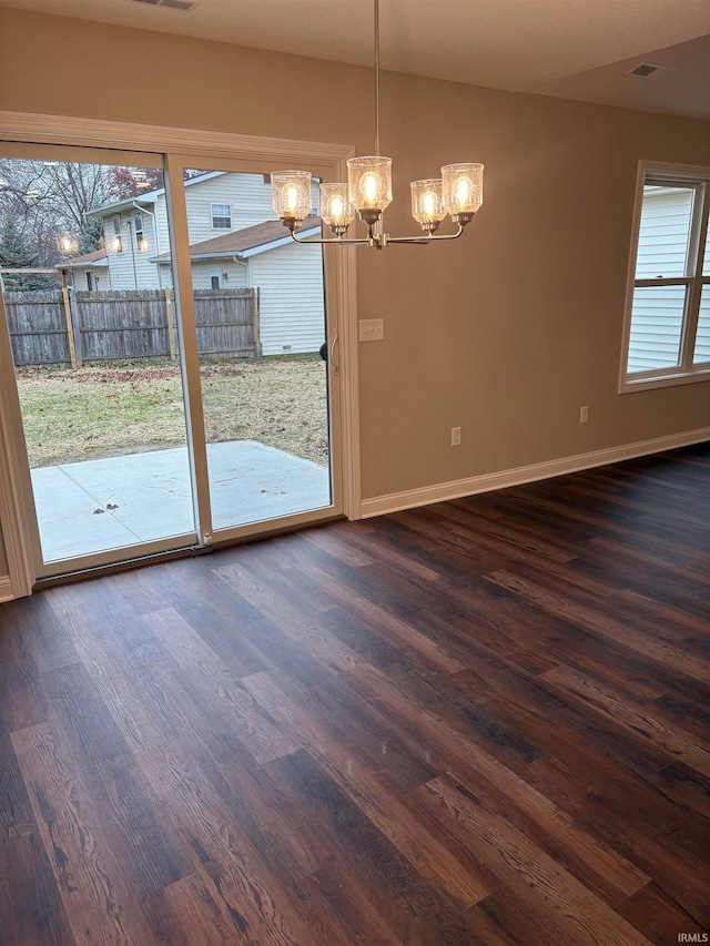 unfurnished dining area featuring a wealth of natural light and dark hardwood / wood-style flooring