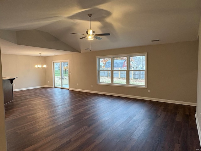 empty room featuring ceiling fan with notable chandelier, dark hardwood / wood-style floors, and vaulted ceiling