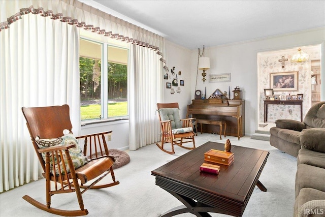 living area with light carpet and ornamental molding