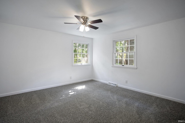 carpeted empty room featuring ceiling fan