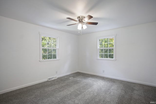 spare room with ceiling fan and carpet