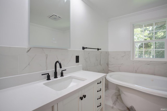 bathroom with vanity, tile walls, a bathtub, and ornamental molding