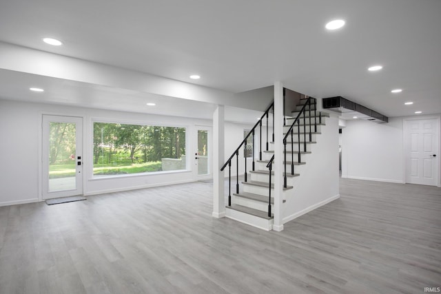 stairs featuring wood-type flooring