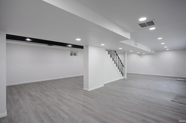 basement with hardwood / wood-style floors