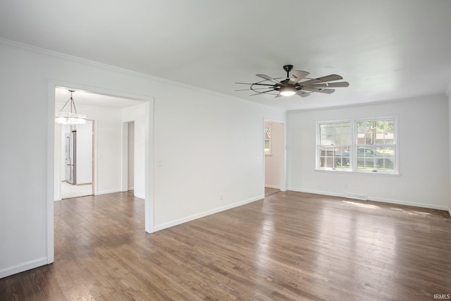 unfurnished room featuring ceiling fan, wood-type flooring, and ornamental molding