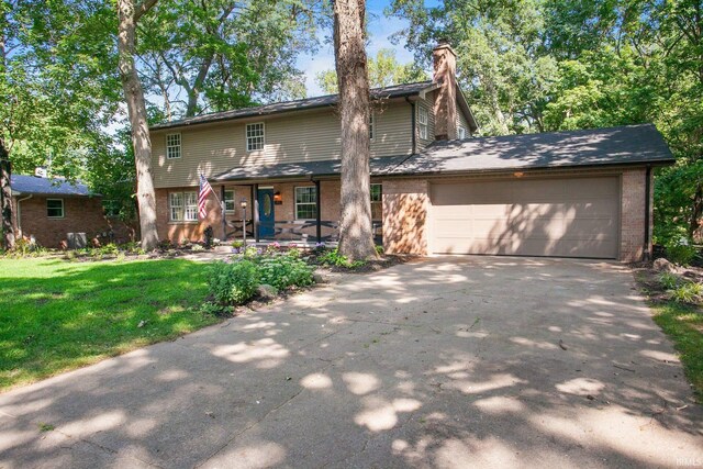 view of front property featuring a front yard and a garage