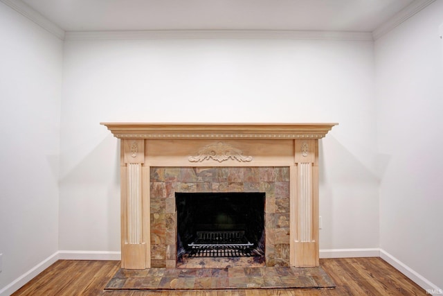 room details with a fireplace, ornamental molding, and hardwood / wood-style floors